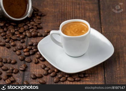 Fresh espresso coffee together decorated with coffee beans on wooden table