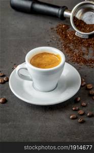 Fresh espresso coffee with coffee beans on dark background