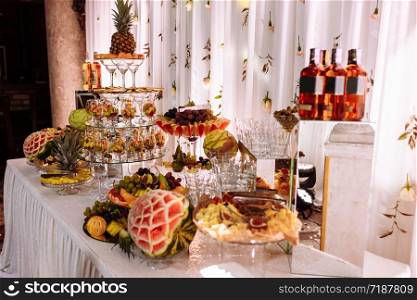 Fresh, exotic, organic fruits, light snacks in a plate on a buffet table. Assorted mini delicacies and snacks, restaurant food at event. Decorated delicious table for a party goodies.