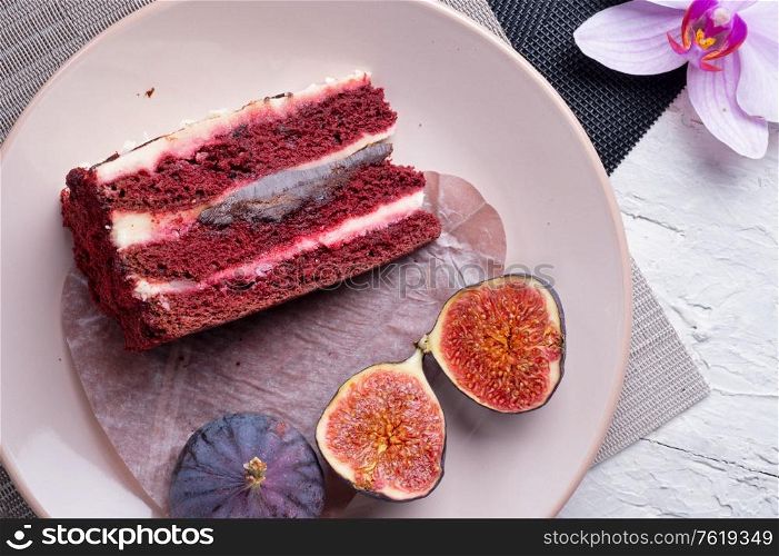 fresh figs and cake served at napkins with orchid. flat lay