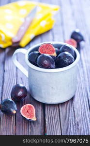 fresh figs in metal cup and on a table