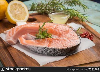 Fresh fish. Salmon. Raw salmon steak with sea salt pepper and herbs. Food background.