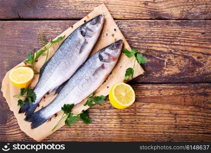 fresh fish sea bass on wooden table