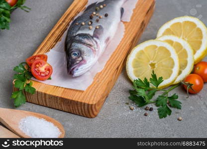 Fresh fish sea bass on wooden table.