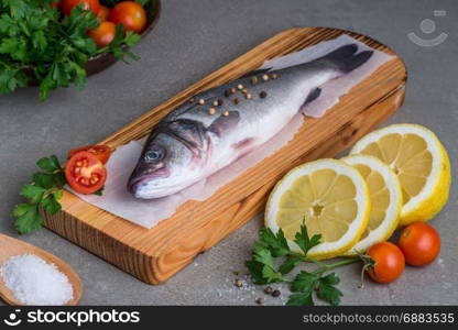 Fresh fish sea bass on wooden table.