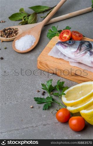 Fresh fish sea bass on wooden table.