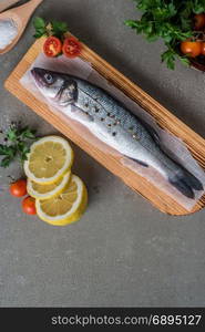 Fresh fish sea bass on wooden table.