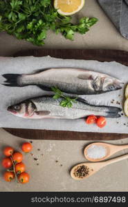 Fresh fish sea bass on wooden table.