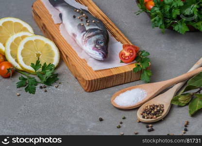 Fresh fish sea bass on wooden table.