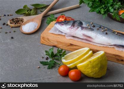 Fresh fish sea bass on wooden table.