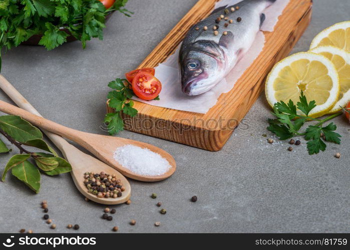 Fresh fish sea bass on wooden table.