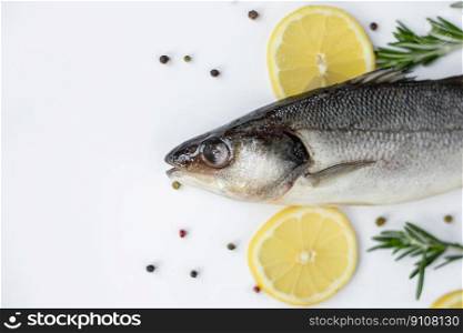 Fresh fish with spices and herbs on table in kitchen. Fresh sea bass. Top view with copy space.. Fresh fish with spices and herbs on table in kitchen. Fresh sea bass.