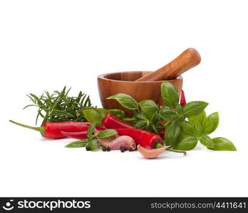 fresh flavoring herbs and spices in wooden mortar isolated on white background