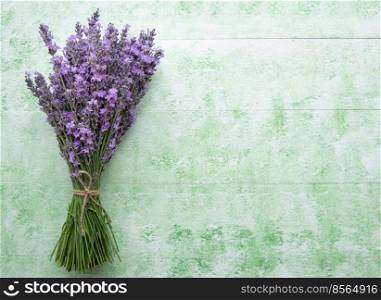 Fresh flowers of lavender bouquet on a green wooden background