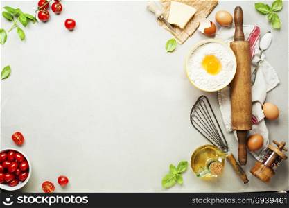 Fresh food ingredients for italian cuisine (Parmigiano, tomato, basil, olive oil, daugh ingredients) on rustic background. Top view