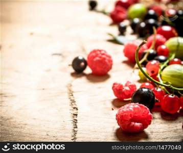 Fresh forest berries . On a wooden background.. Fresh forest berries .On wooden background.