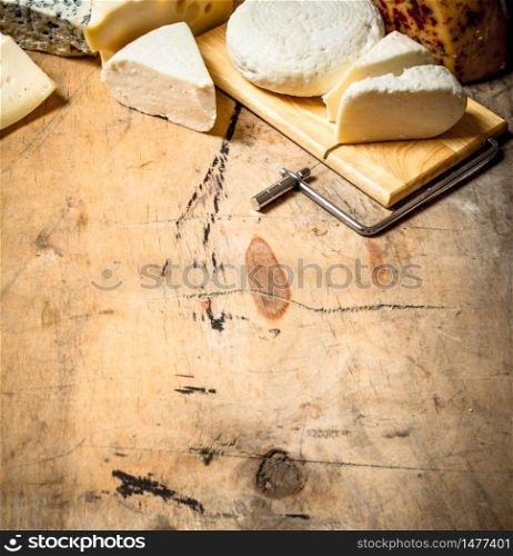 Fresh fragrant cheese on a special Board. On a wooden table.. Fresh fragrant cheese on a special Board.