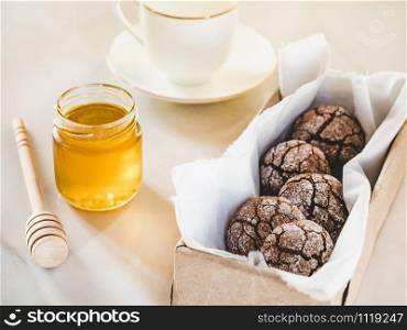Fresh, fragrant handmade cookies, glass of milk and jar of honey. Close-up, top view. Tasty and healthy eating concept. Fresh cookies, glass of milk and jar