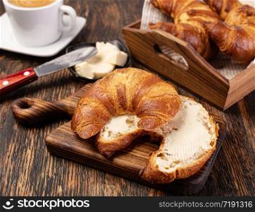 Fresh French croissants with butter on a table. Fresh croissants with butter