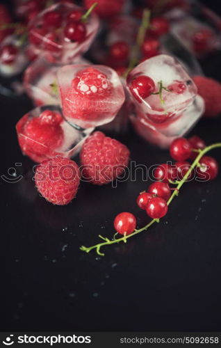 Fresh frozen berries raspberry and red currant. Frozen berries on wooden table