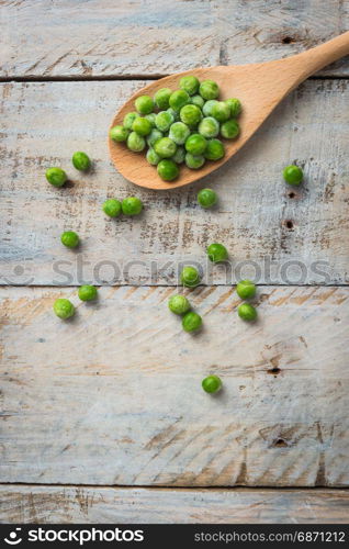 Fresh frozen peas on a spoon. Vegetable food background healthy vegetarian natural meal.