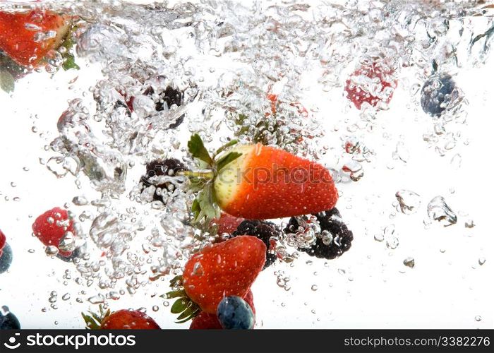 Fresh fruit background in water over white