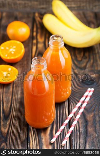 fresh fruit juice in bottle and on a table