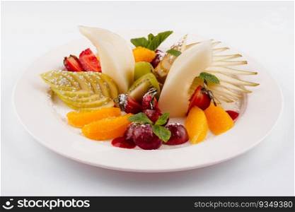 Fresh fruit salad on white plate isolated on white