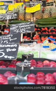 Fresh fruits at a greengrocer&rsquo;s stall focus on the strawberries