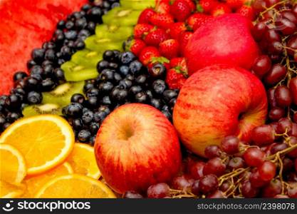 Fresh fruits concept, Arrangement of kiwi orange apple and assorted burry as background.