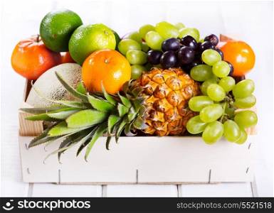 fresh fruits in a box on wooden table