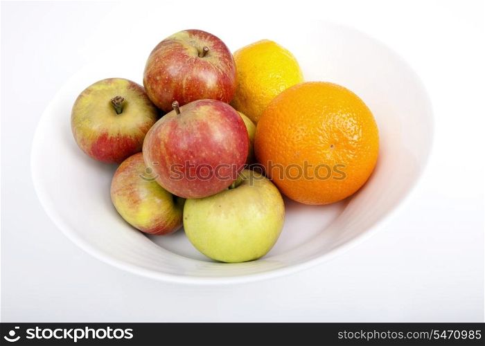Fresh fruits in plate against white background
