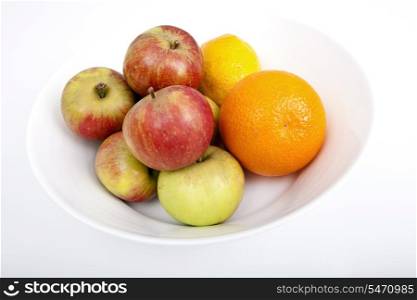 Fresh fruits in plate against white background
