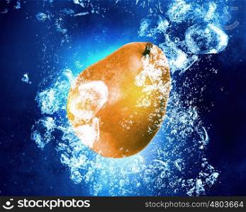 Fresh fruits. Juicy pear falling into clear blue water