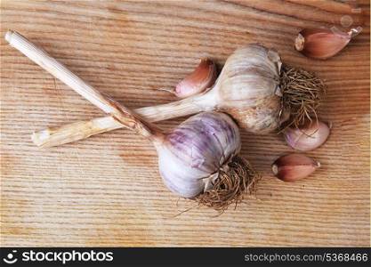 fresh garlic bulb isolated on wooden background