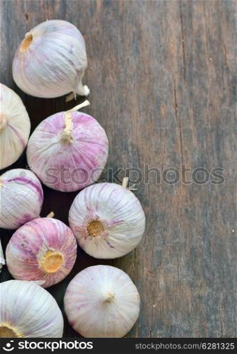 Fresh garlic isolated on old wooden background, top view