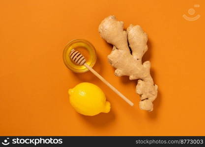 Fresh ginger root lemon honey orange background. Alternative medicine, vegetarianism, ayurveda, natural medicines. Top view flat lay copy space. Fresh ginger root lemon honey orange background. Alternative medicine vegetarianism