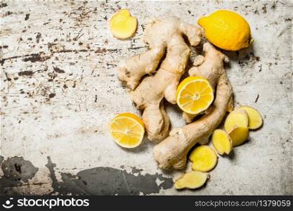 Fresh ginger with lemons. On rustic background.. Fresh ginger with lemons.