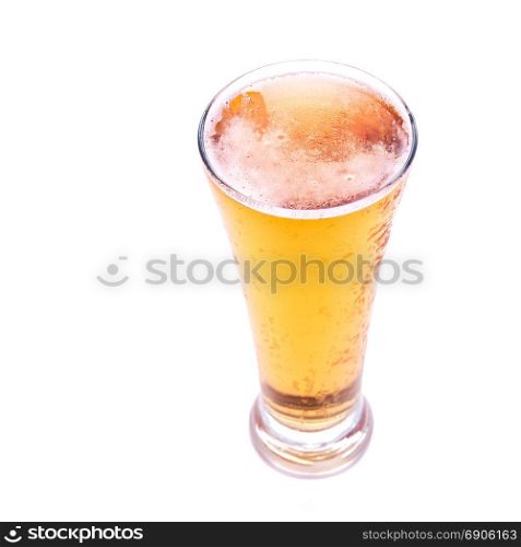 Fresh gold cold and delicious lager beer in glass over white background