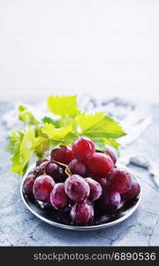 fresh grape on plate and on a table