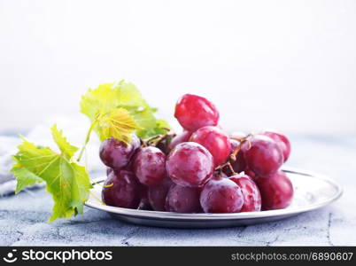 fresh grape on plate and on a table