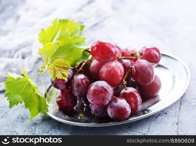 fresh grape on plate and on a table