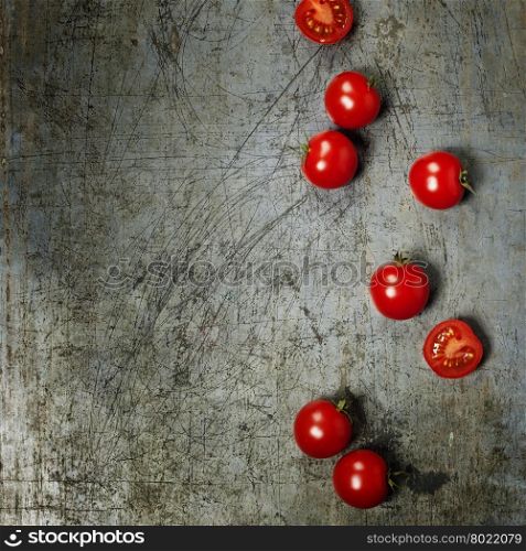 Fresh grape tomatoes on rustic background with copyspace