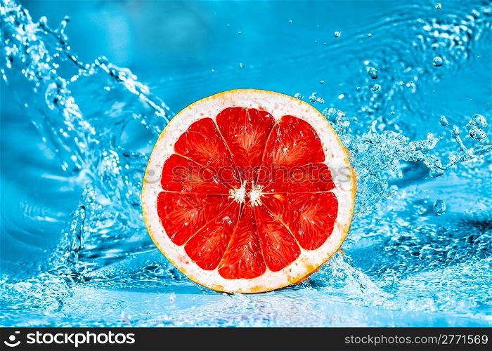 Fresh grapefruit in water splashes