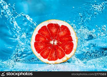 Fresh grapefruit in water splashes
