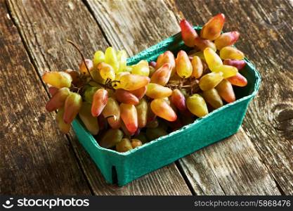 Fresh grapes on old wooden background
