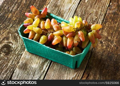 Fresh grapes on old wooden background