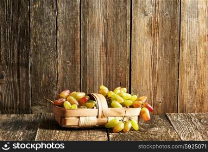 Fresh grapes on old wooden table