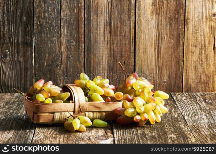 Fresh grapes on old wooden table