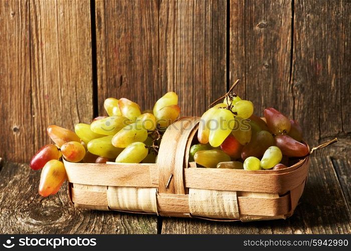 Fresh grapes on old wooden table